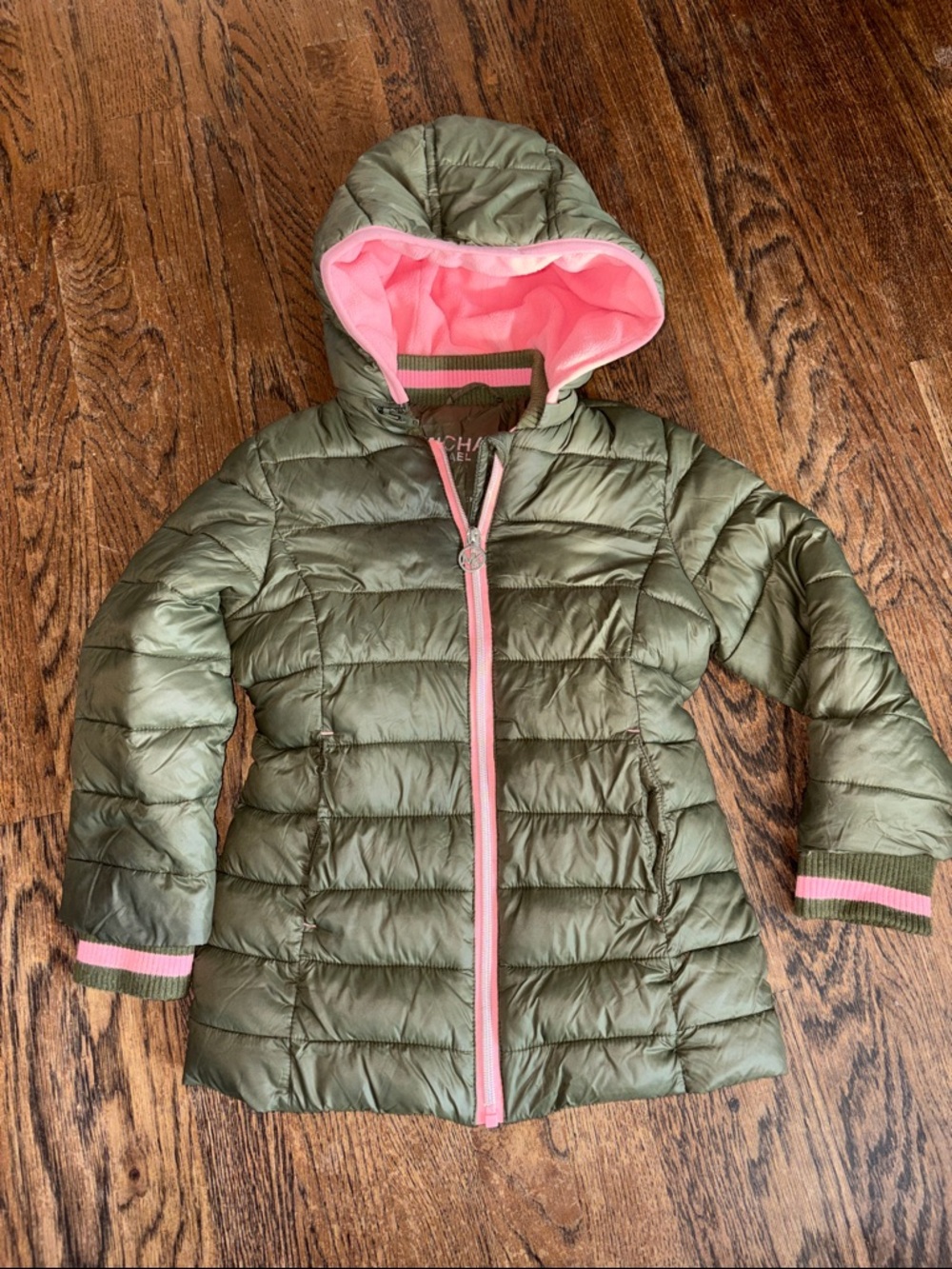 Michael Kor’s Olive Green Puffer Jacket lined with pink fleece.